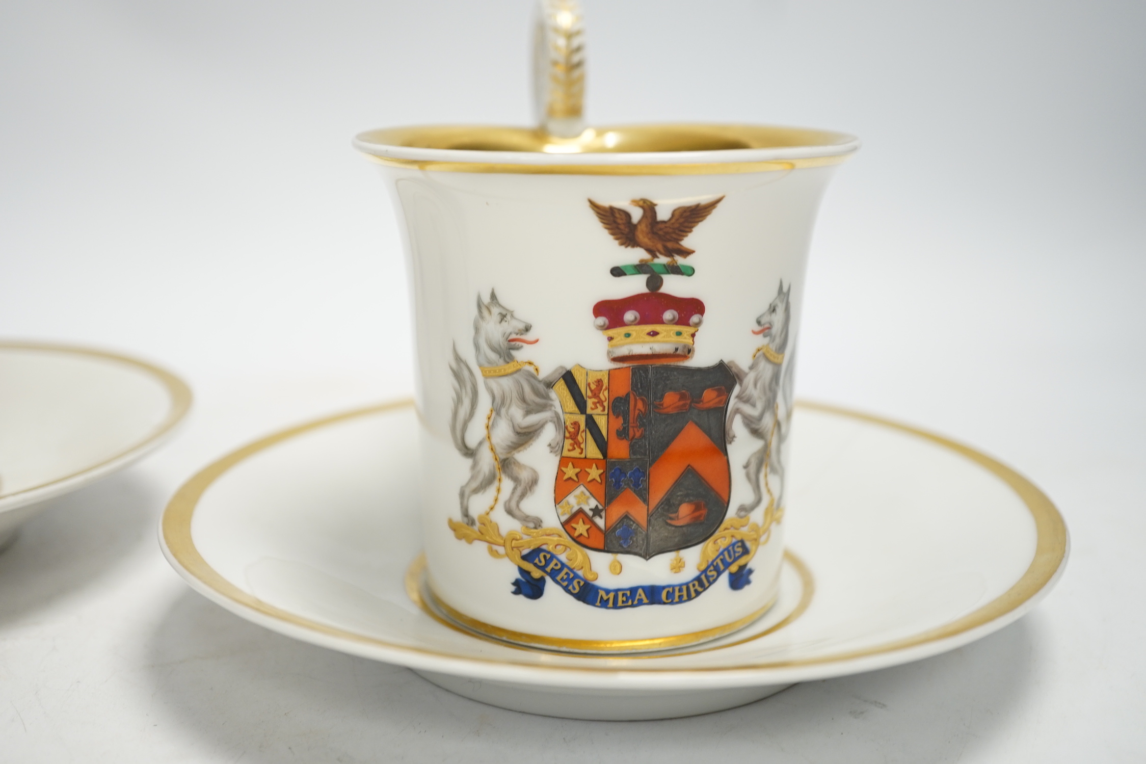 A pair of German porcelain armorial cups and saucers, one saucer reads ‘Lord Bingham s/m Y. Powell. Born 1848’